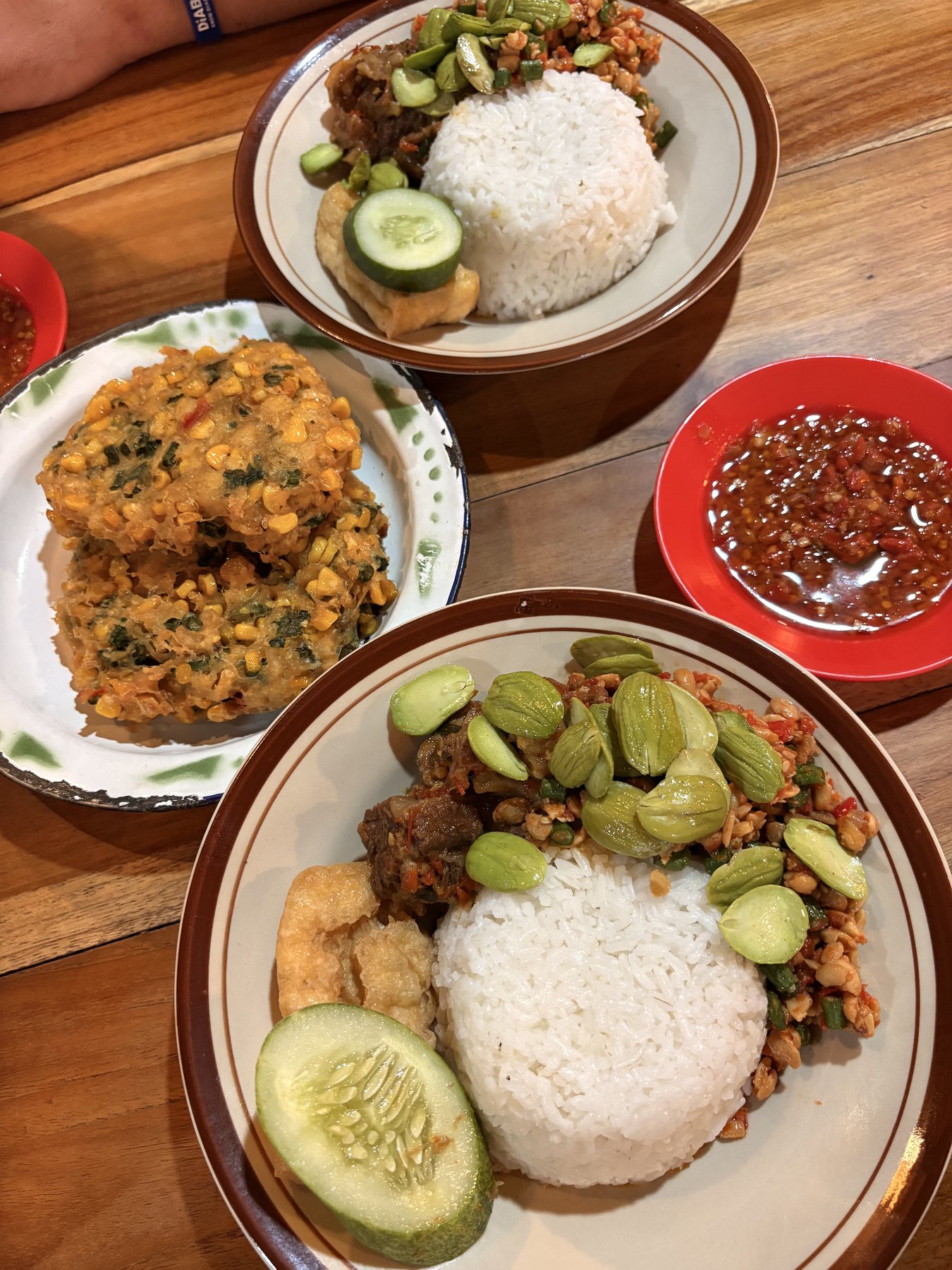 Rice, vegetables, fritters and sauces served at a restaurant in Indonesia